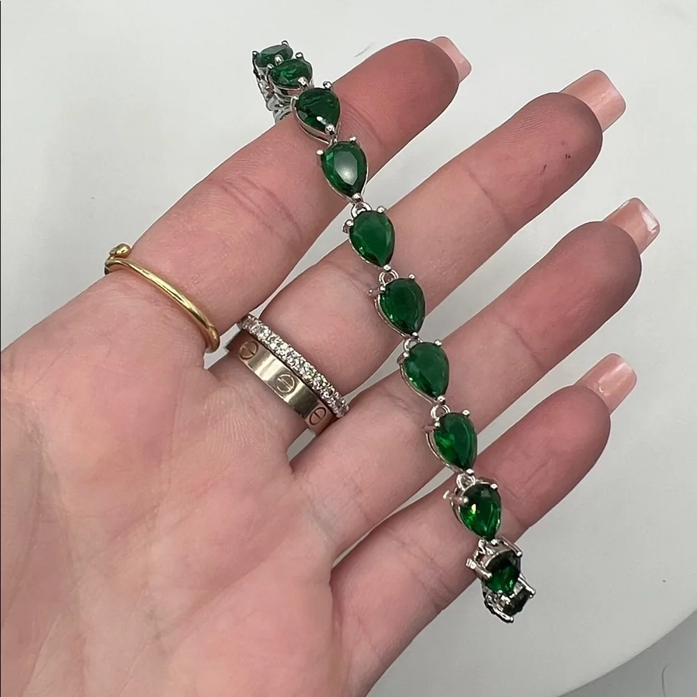 198. White Gold Plated Bracelet with Pear Shaped Emeralds 7”